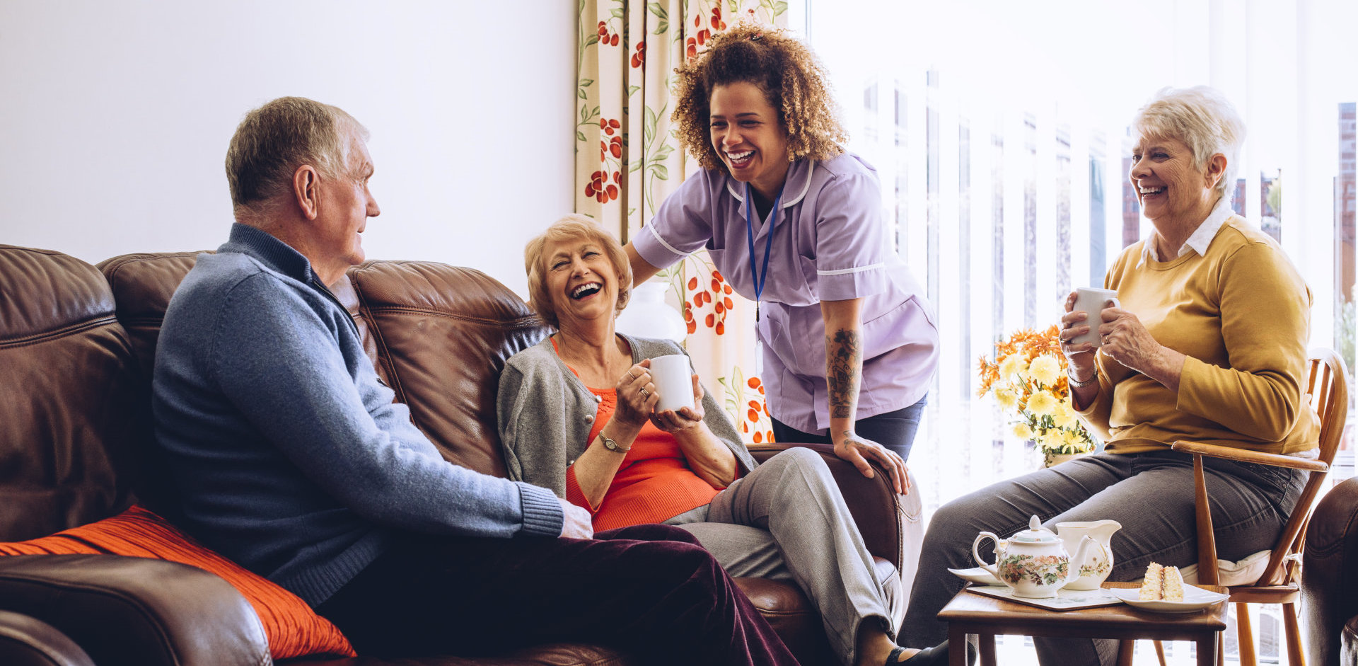 happy elderly couple talking to a caregiver