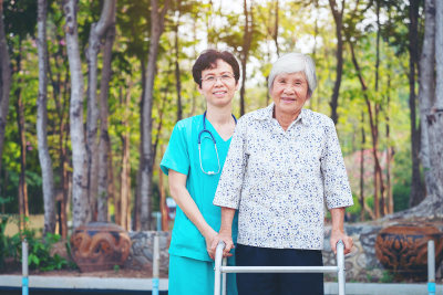 happy senior woman and caregiver