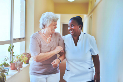 caregiver and senior woman walking