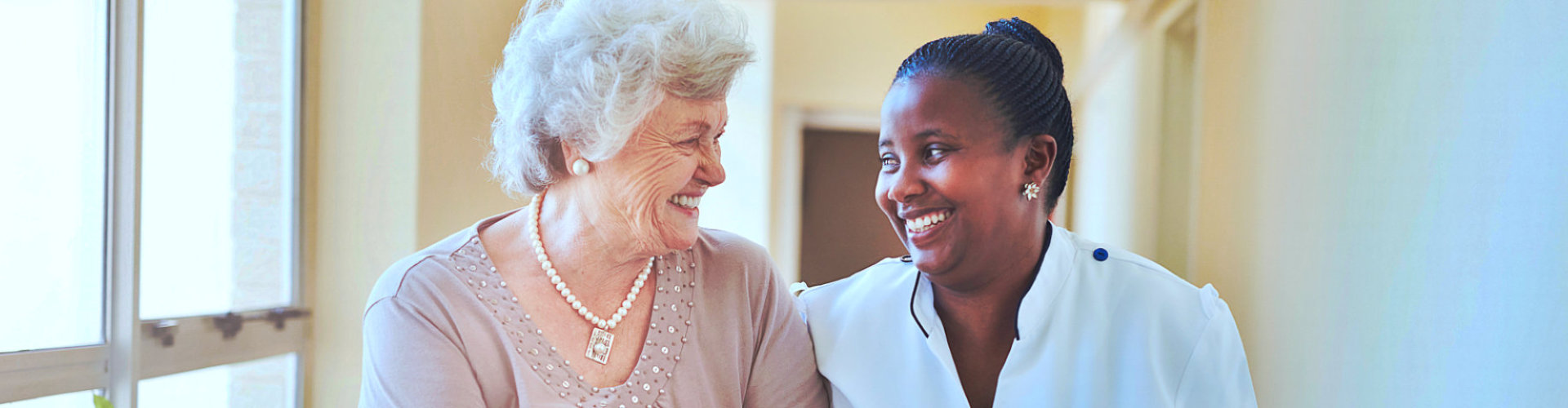 caregiver and senior woman walking